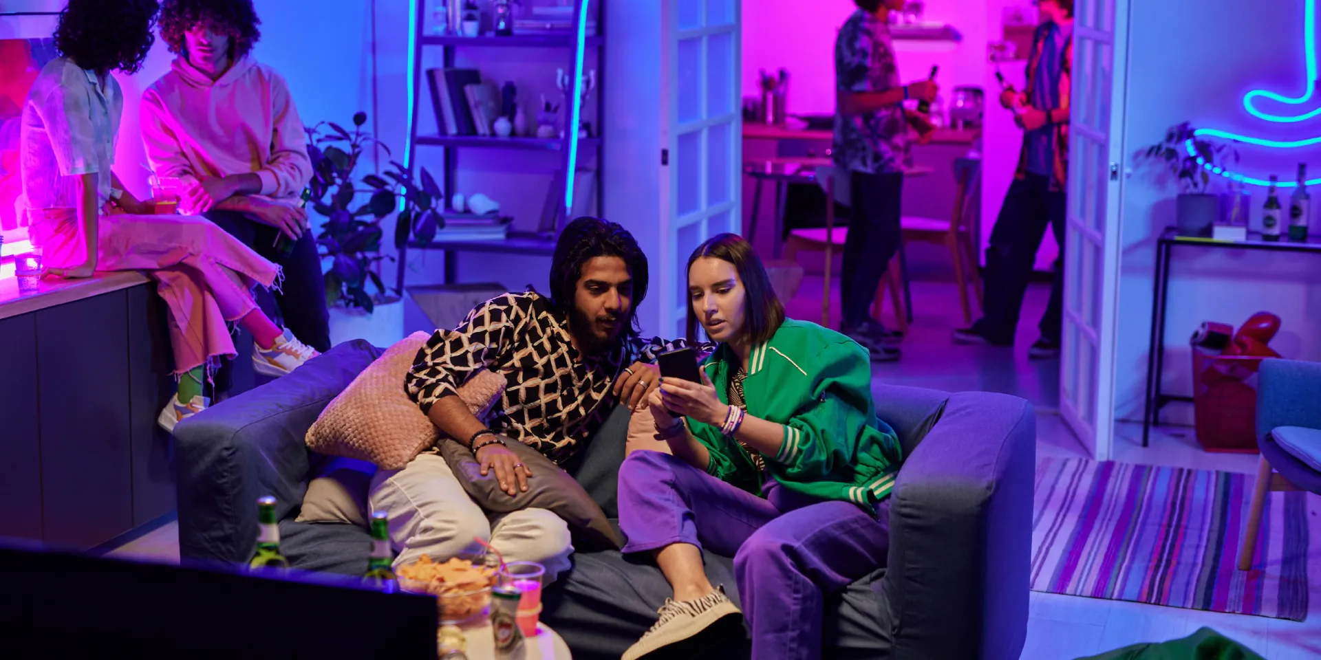 young people hanging out at home with smart lighting 